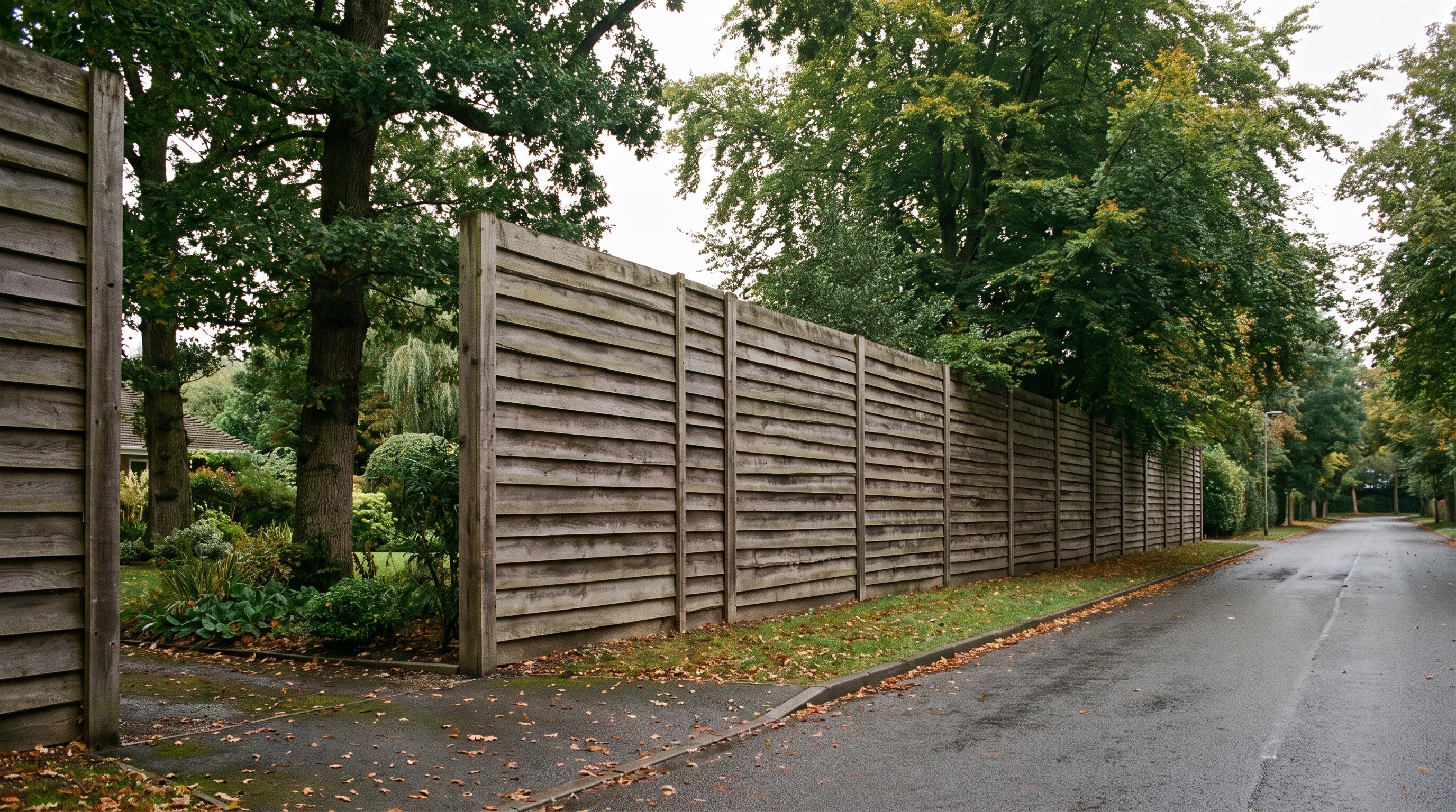 Acoustic timber fencing screening a Hertfordshire garden from a road